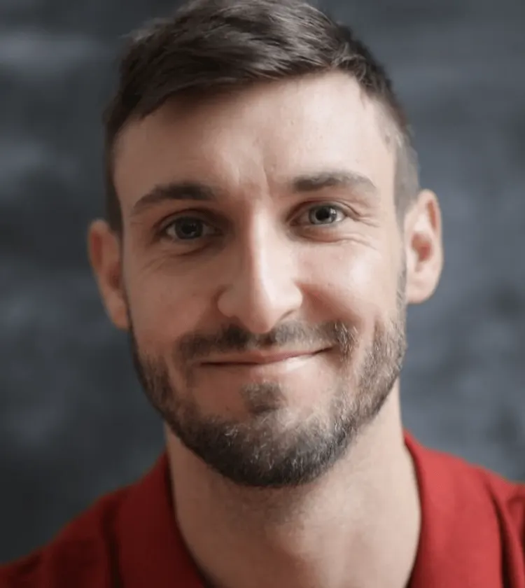 Man with a short beard, smiling, suitable for round face beard style inspiration 