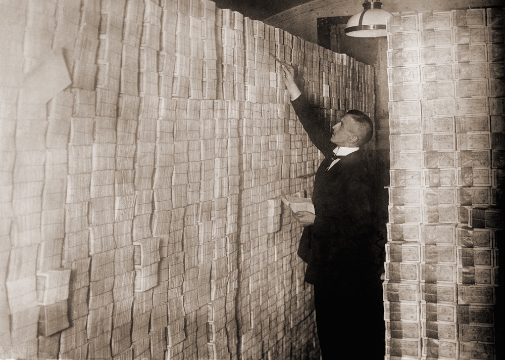 Piles of German money in a Berlin bank during the post-World War I hyper-inflation. In 1923 a US dollar was worth 800 million German Marks.