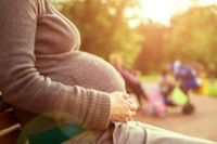 pregnant woman sitting on bench