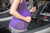 Pregnant woman walking on treadmil for exercise