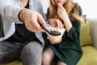 couple watching TV and snacking