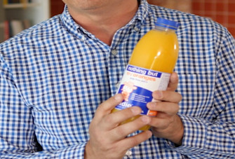 Dr Sultan holding up fruit juice container