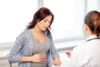 pregnant woman discussing medications in pregnancy with doctor
