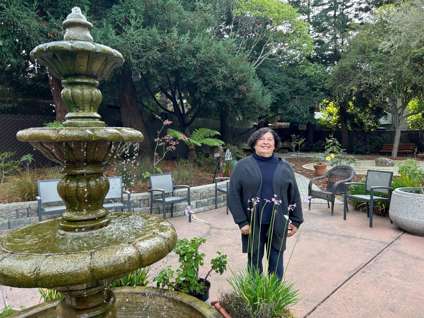 Participant standing outside by fountain 