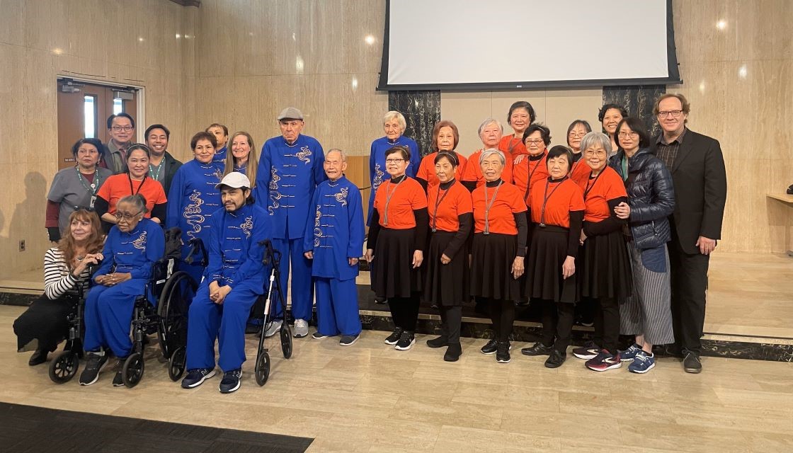 Image of Nick Sager with tai-chi group of 26 people. 