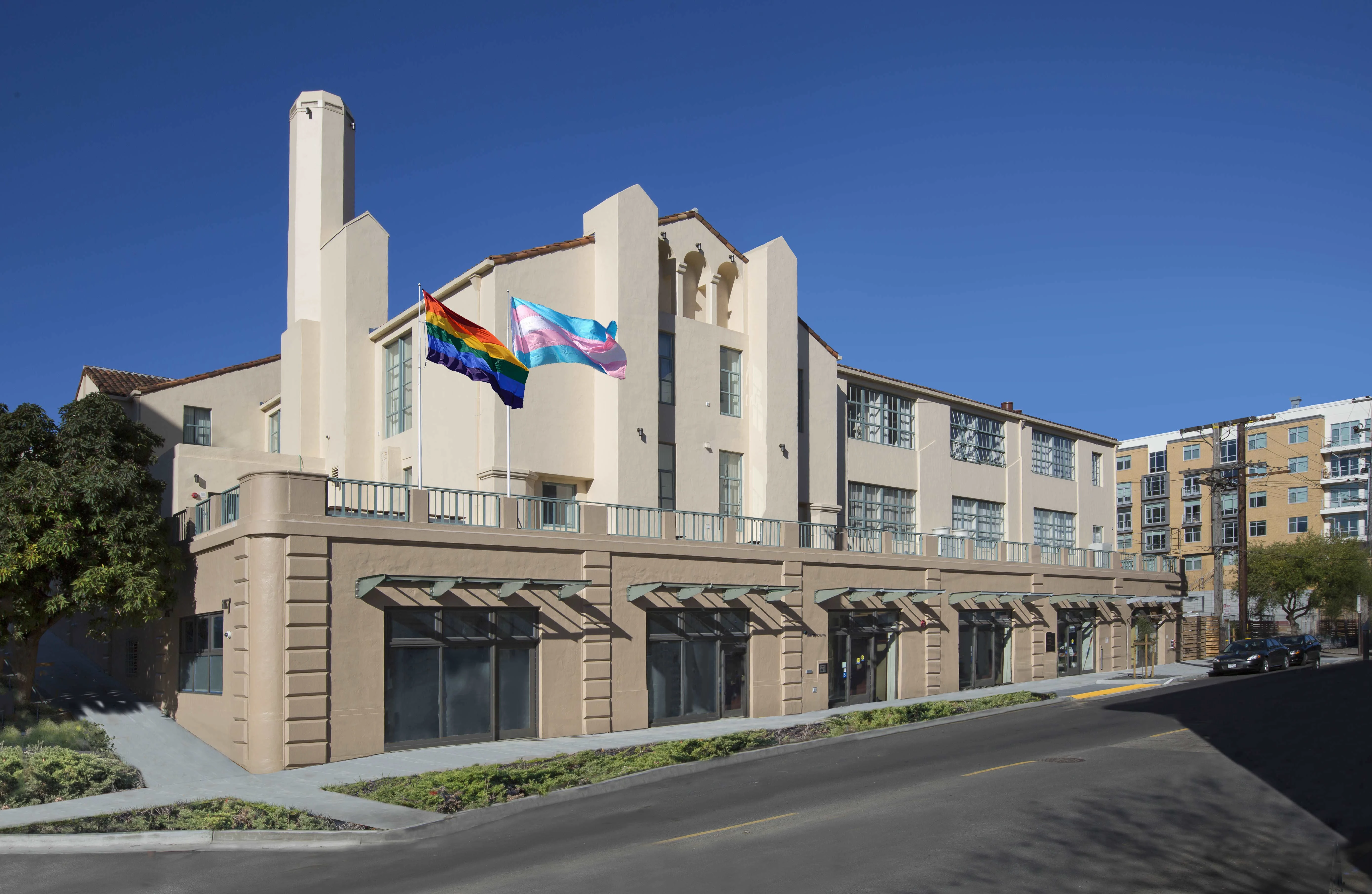 A front view of OnLok's location with the LGBTQ and Trans flag waving on a flagpole