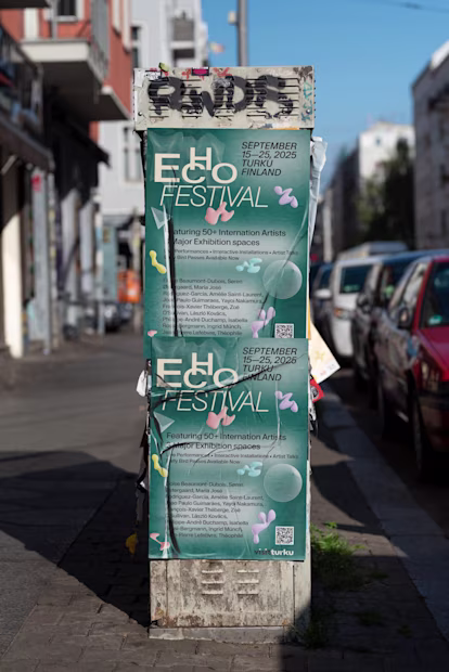 Echo Festival Poster: A Turquoise Echo Festival Poster Displayed On A Weathered Electrical Box On An Urban Street. The Poster Features Abstract Geometric Shapes And Announces Dates For September 2025 In Turku, Finland. The Scene Shows Natural Wear And Environmental Aging Effects.