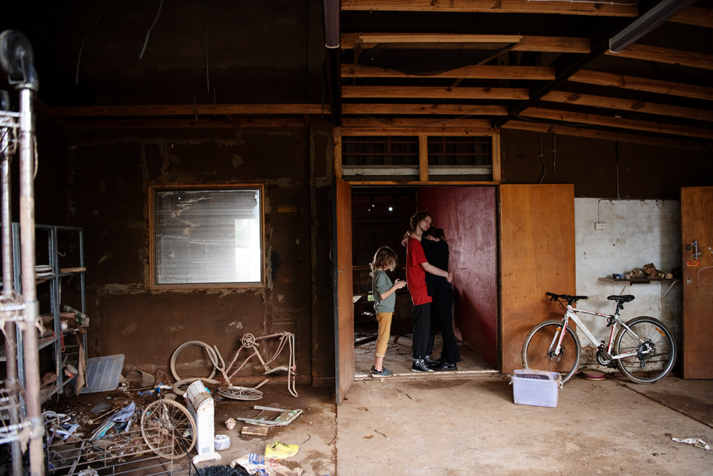 Strummer O’Brien with his brother Rudi and girlfriend Sophie Walsh in their home in South Lismore that has now become condemned. Hundreds of homes have been condemned in the flood affected town of Lismore leaving thousands of residents displaced and without a home.