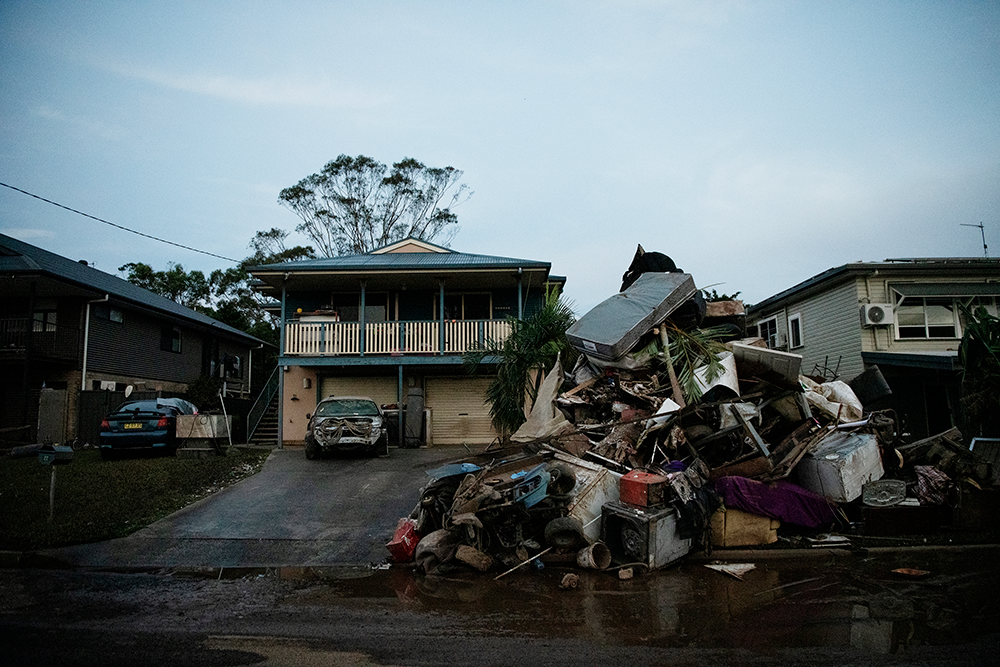 A house in south Lismore has its contents dumped on the street days after the flood in February. Every home in the Lismore basin had a pile this high. It was heartbreaking to see cherished belongings in rubbish piles only to end up in landfill. 