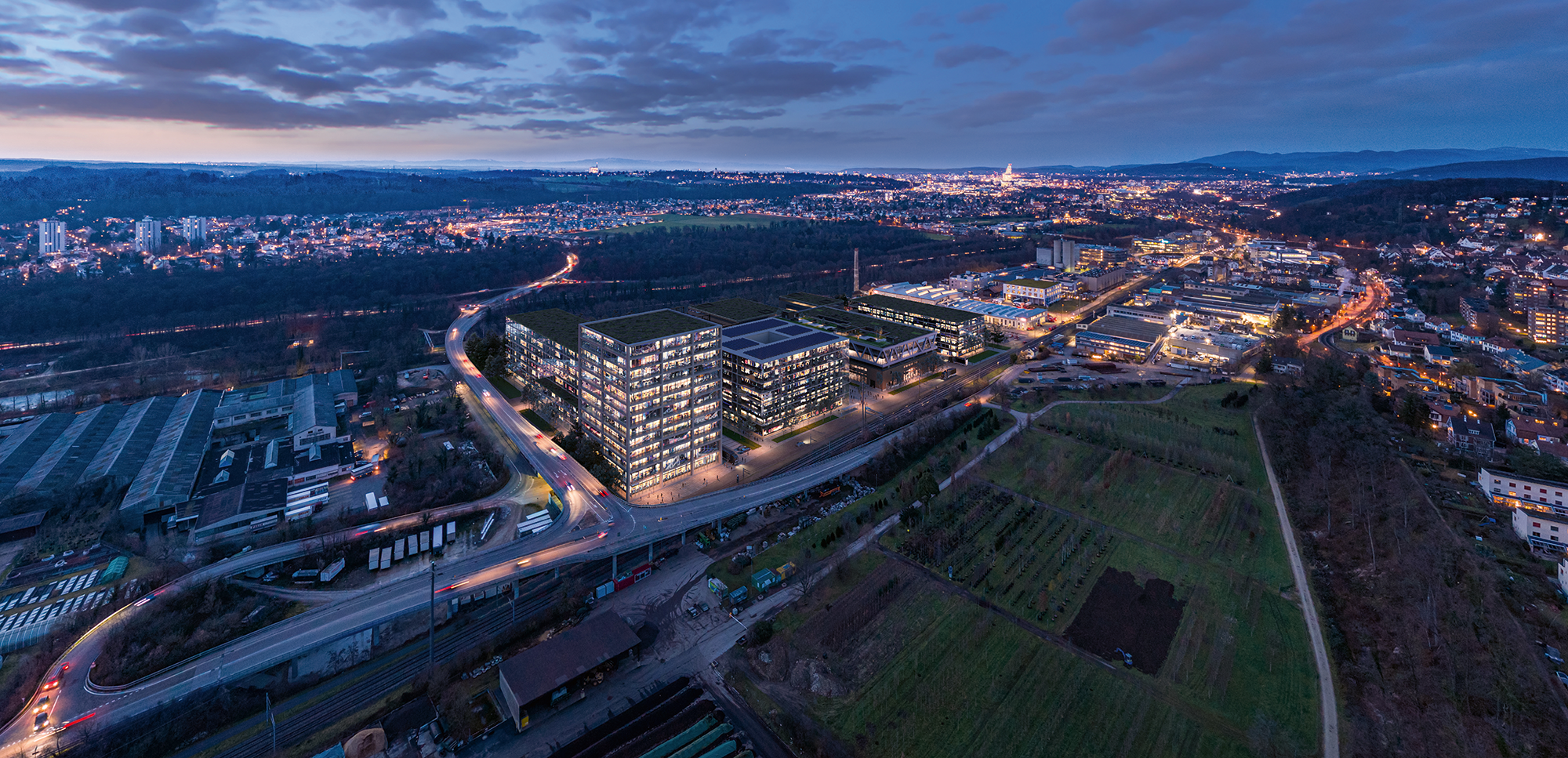 Luftaufnahme von Uptown Basel bei Nacht