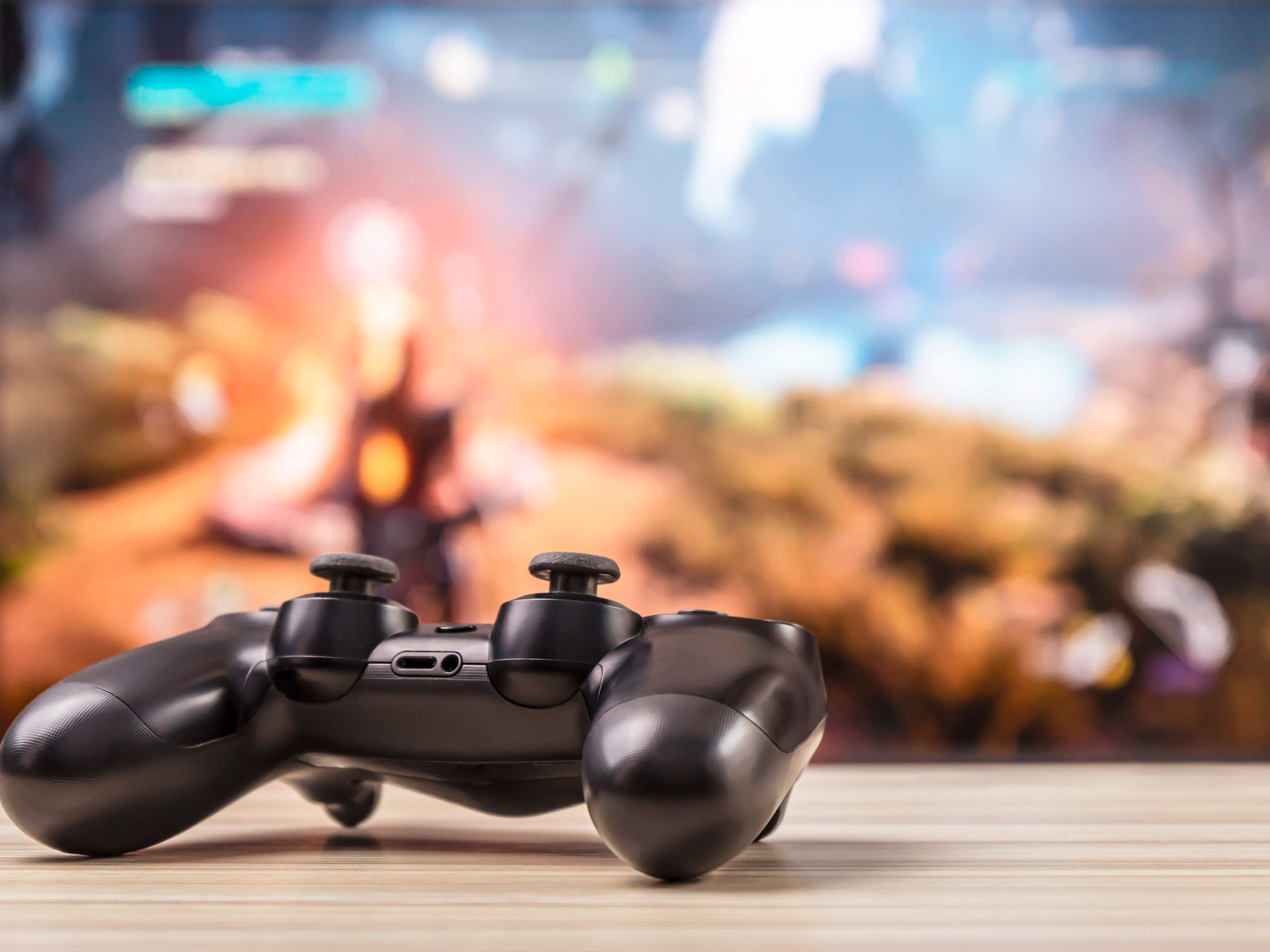 Fernseher mit Spielkonsole im Vordergrund