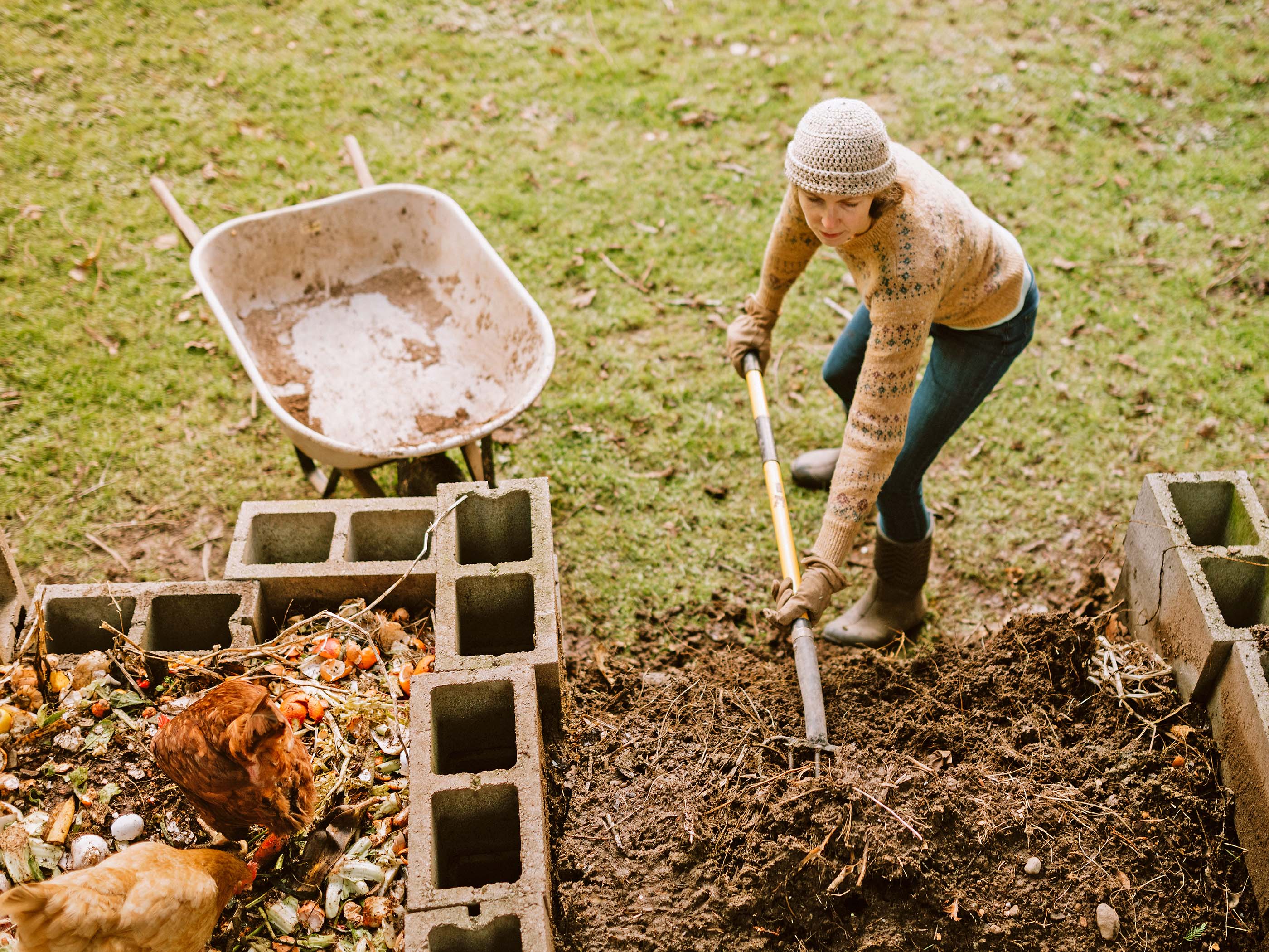 Une femme pellete du compost