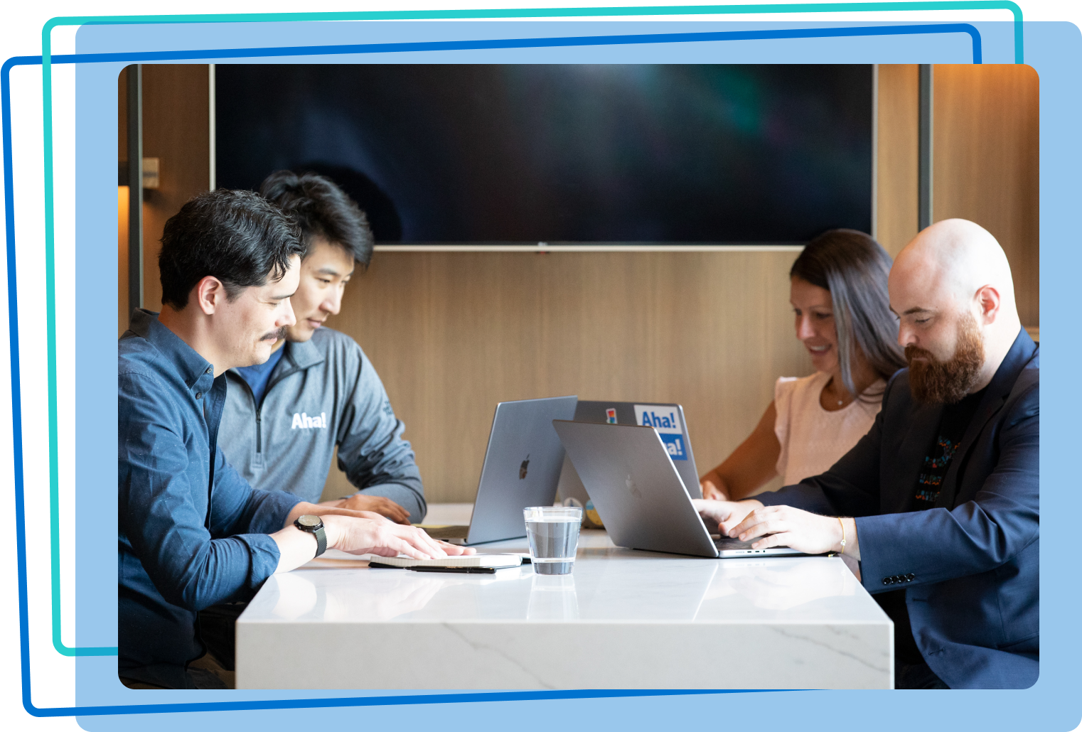 Four people working on computers