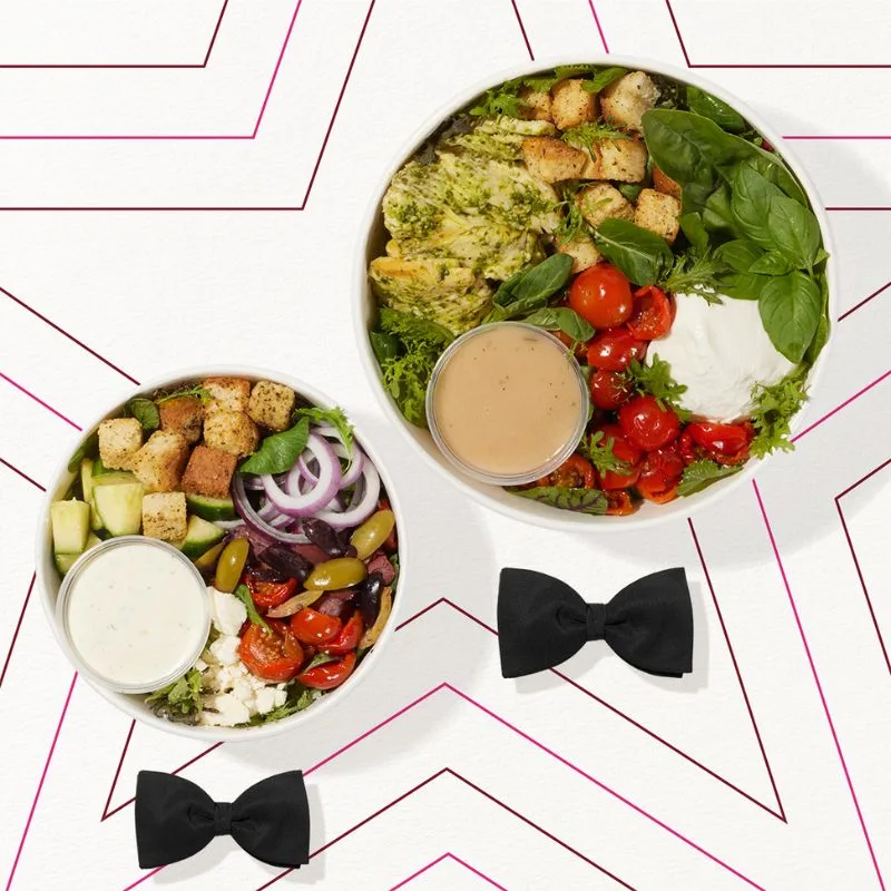 Two of Pret's new salad bowls with bow ties underneath. The Pret-A-Manger star is outlined as a background.