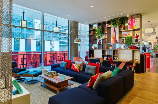 hotel living room in Austin Downtown with couches, a wall of art and outdoor seating