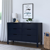 Dresser in a room with lamp and plant