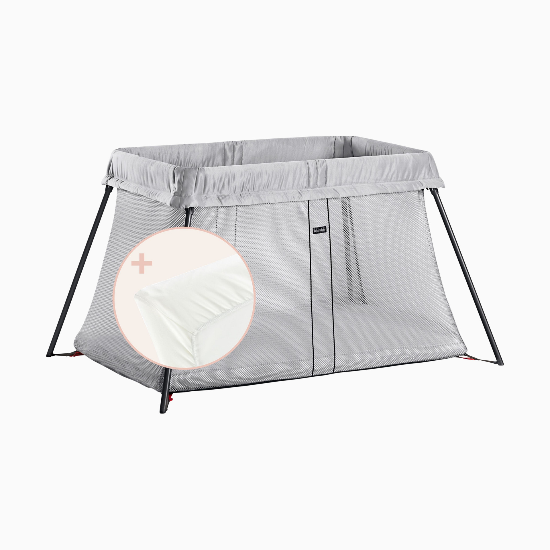Gray travel crib with mesh side and fabric cover on a plain background.