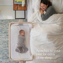 Adult in bed with baby in Halo Bassinest