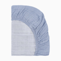 Close-up of the ruffled edge and quilted texture of the sheet.