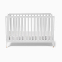 White crib with vertical slats and mattress