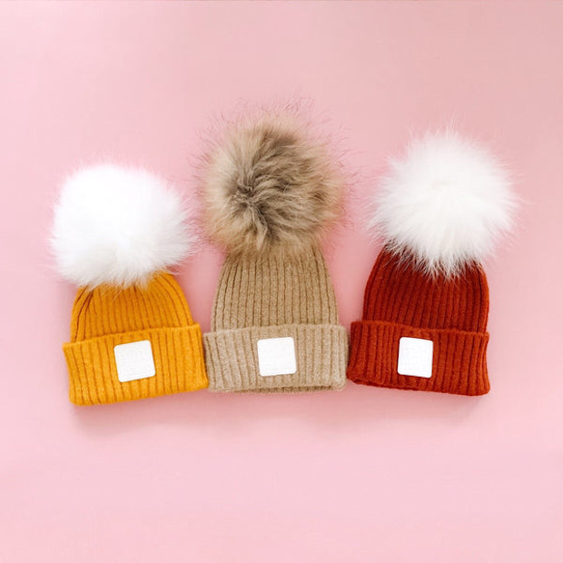 OLE design “minimalist” hat with pompom - $50.00.