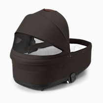 Dark brown Cybex Cot S Lux bassinet with mesh insert from the side.