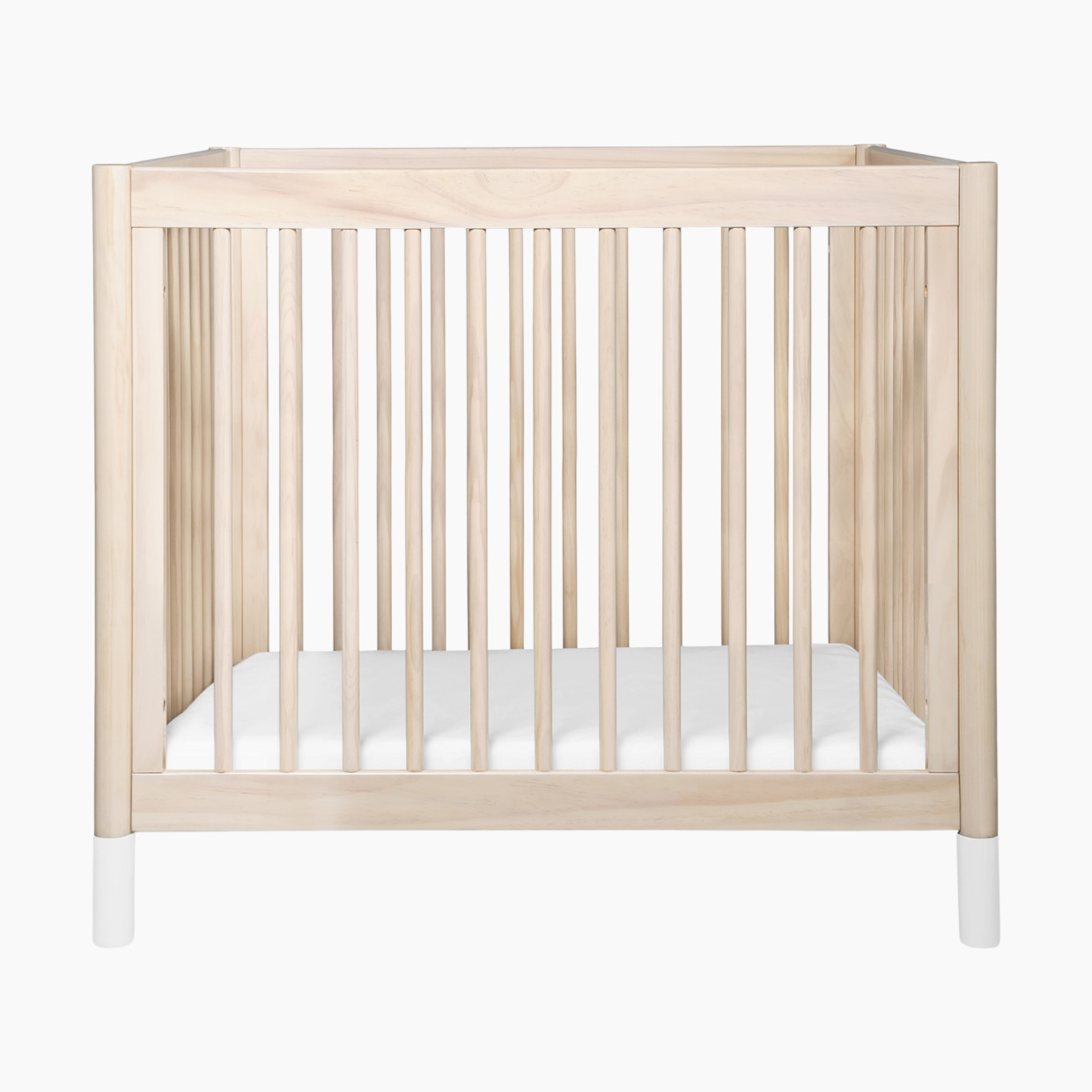 babyletto Gelato 4-in-1 Convertible Mini Crib - Washed Natural Finish With White Feet.
