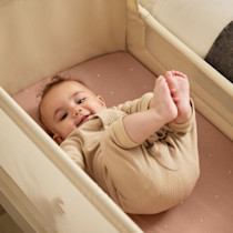 Interior view of bassinet with baby laying inside