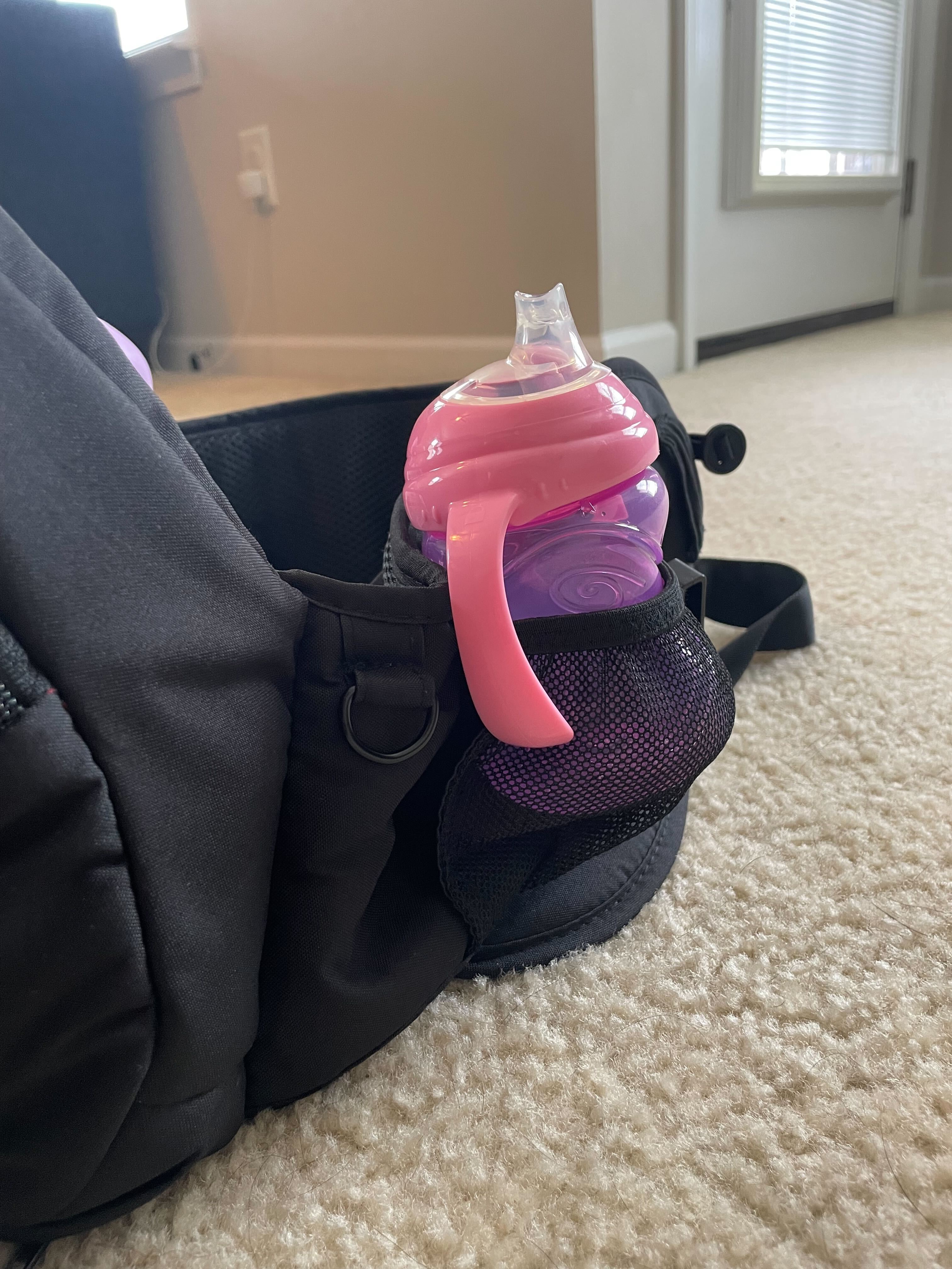 The two cinched pockets allow you to carry a bottle or sippy cup.