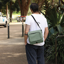 Person wearing a green crossbody bag