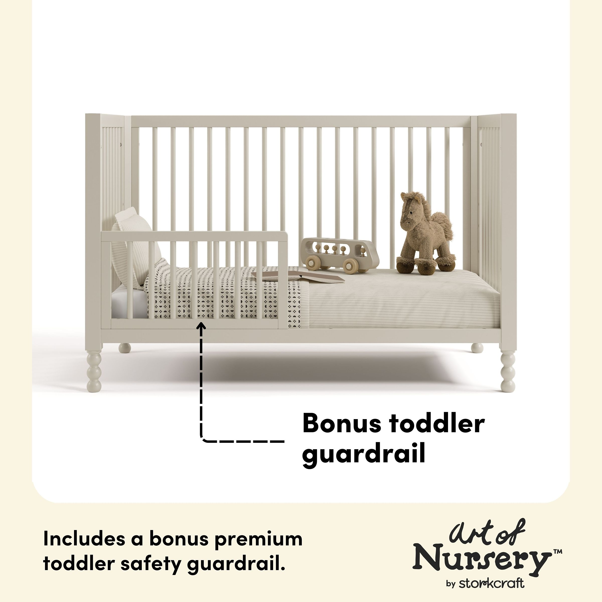White crib with toddler guardrail and stuffed animal.