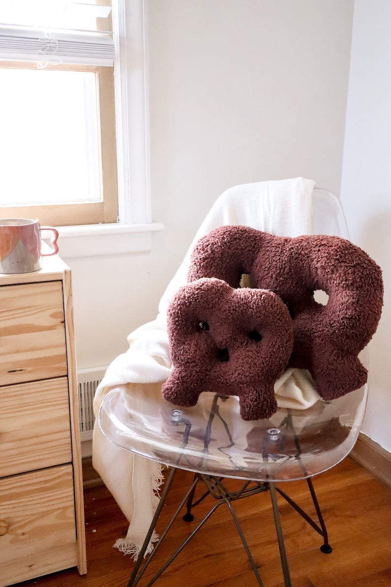 Mod Plush The Soft Pretzel Pillow in Chocolate.