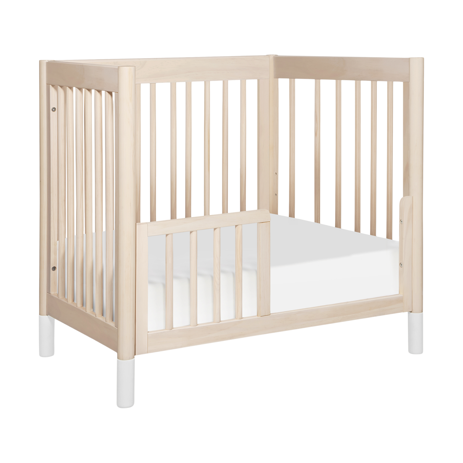 babyletto Gelato 4-in-1 Convertible Mini Crib - Washed Natural Finish With White Feet.