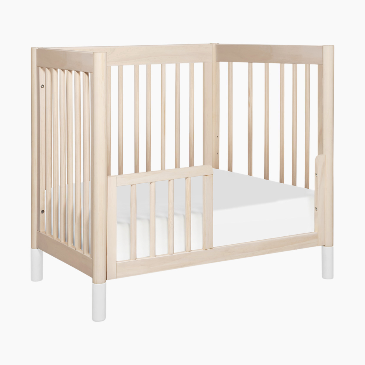 babyletto Gelato 4-in-1 Convertible Mini Crib - Washed Natural Finish With White Feet.