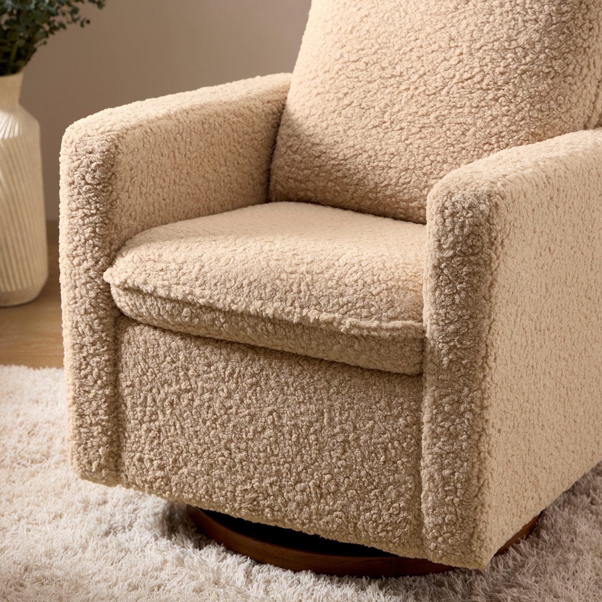 babyletto Cali Pillowback Swivel Glider - Chai Shearling With Dark Wood Base.