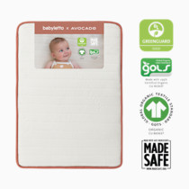 Minimal packaging view of the mini crib mattress by Babyletto x Avocado with a photo insert