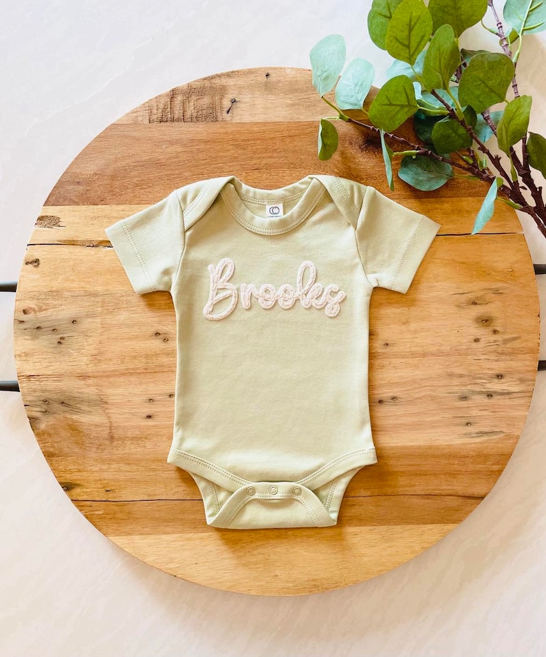 TheBonnyBabyCo Custom Hand Embroidered Felt Name Short Sleeve Bodysuit.