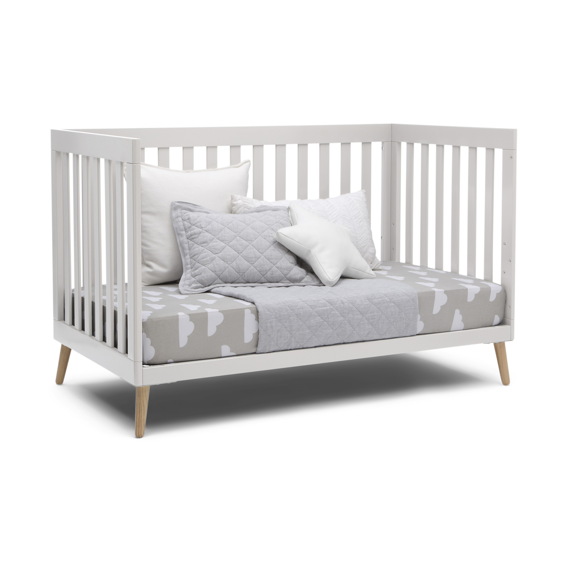 white crib with wood legs