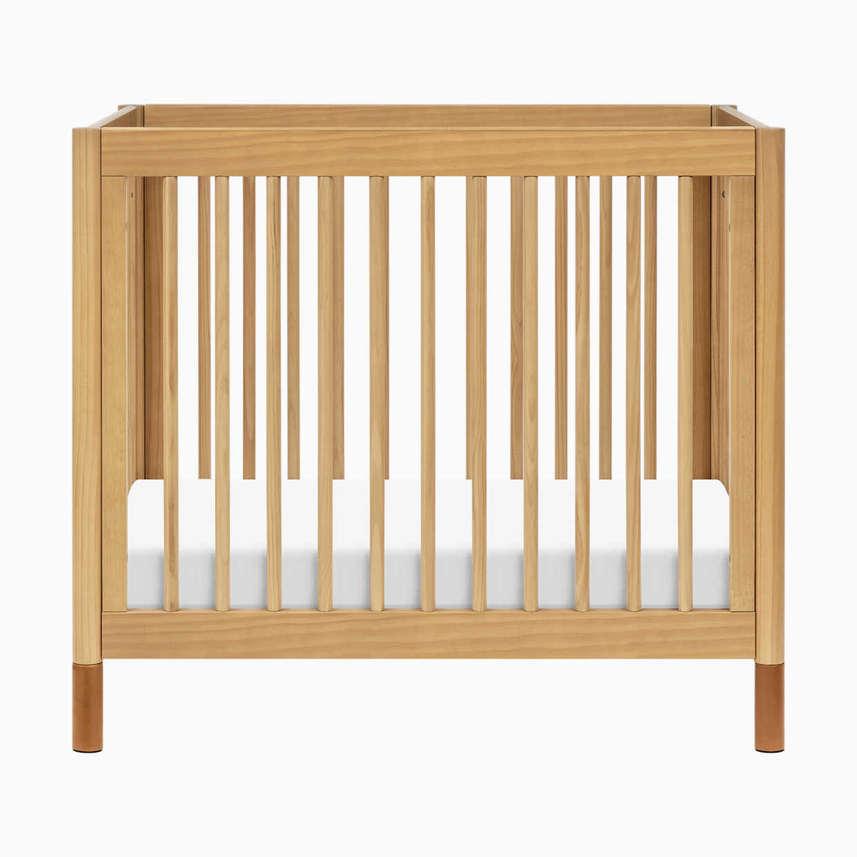 babyletto Gelato 4-in-1 Convertible Mini Crib - Honey With Vegan Tan Leather Feet.