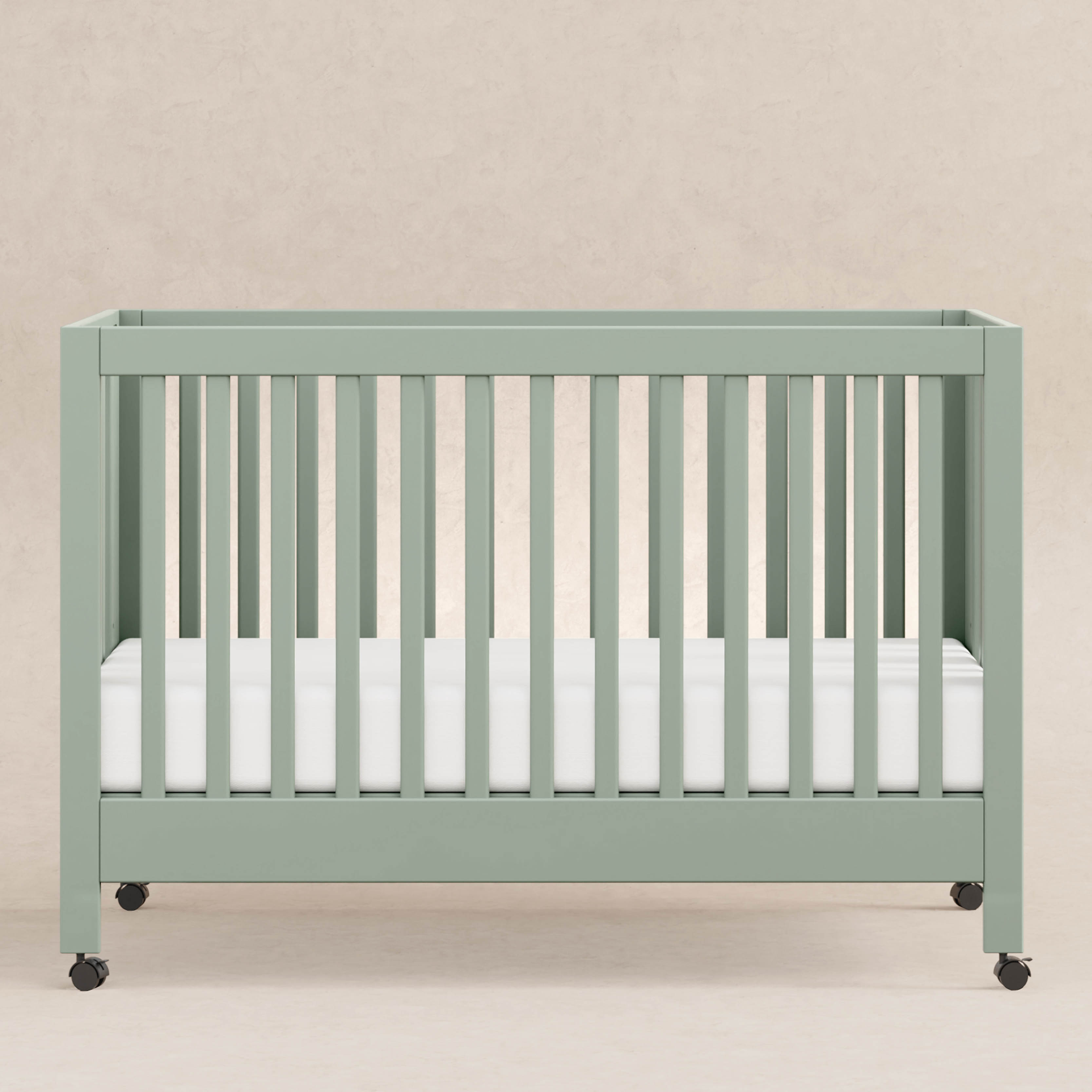 babyletto Maki Portable Folding Crib with Toddler Bed Conversion Kit - Light Sage.