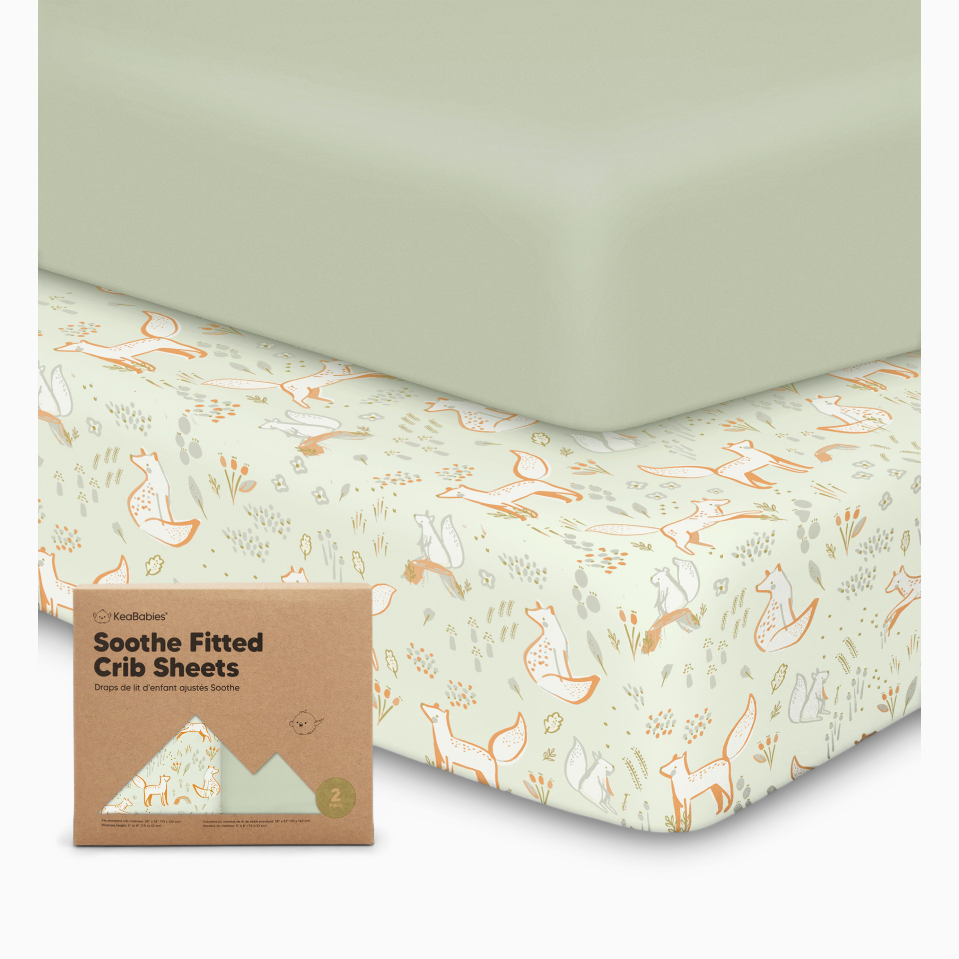 Crib styled with patterned fitted sheet and packaging.