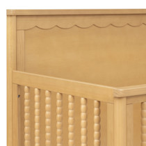 Close-up of headboard scalloped top rail and wood grain