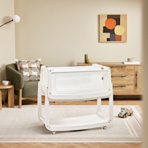 SnuzPod5 bassinet set up in living room on rug