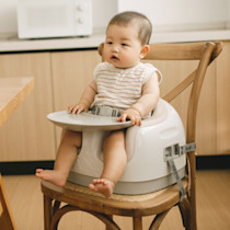 Baby seated in Bumbo Multi Seat in White Sand/White