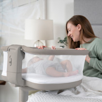 Woman interacting with a baby in the swivel sleeper.