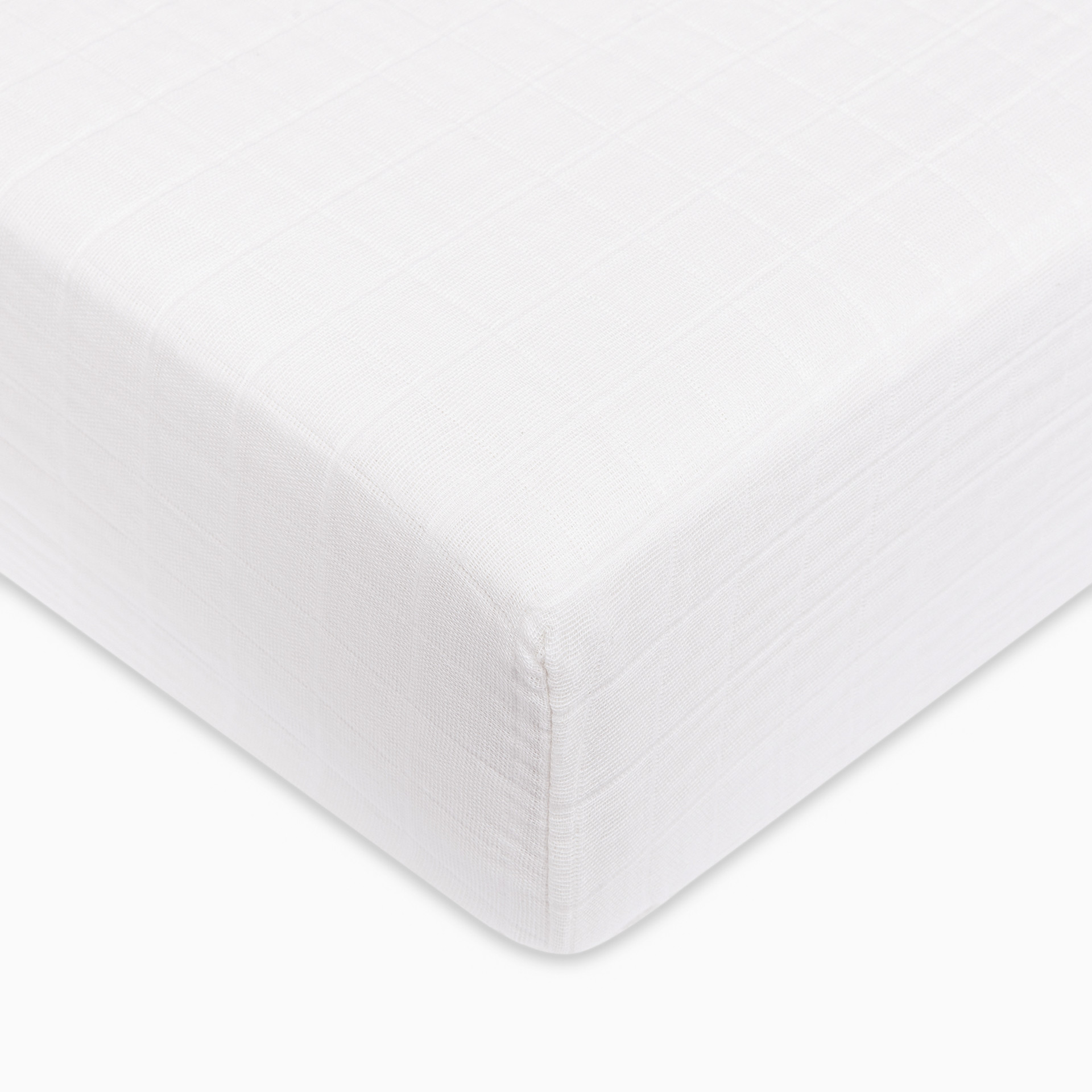 Plain white crib sheet fabric with a subtle texture.