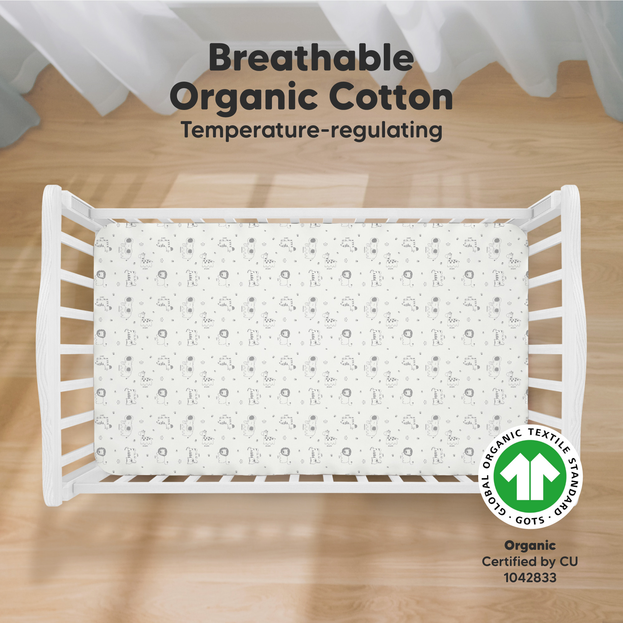 White fitted crib sheet with small animal print on a white background.