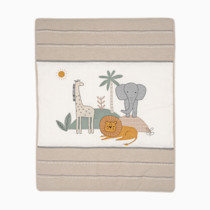 Flat lay of crib bedding set with animal print