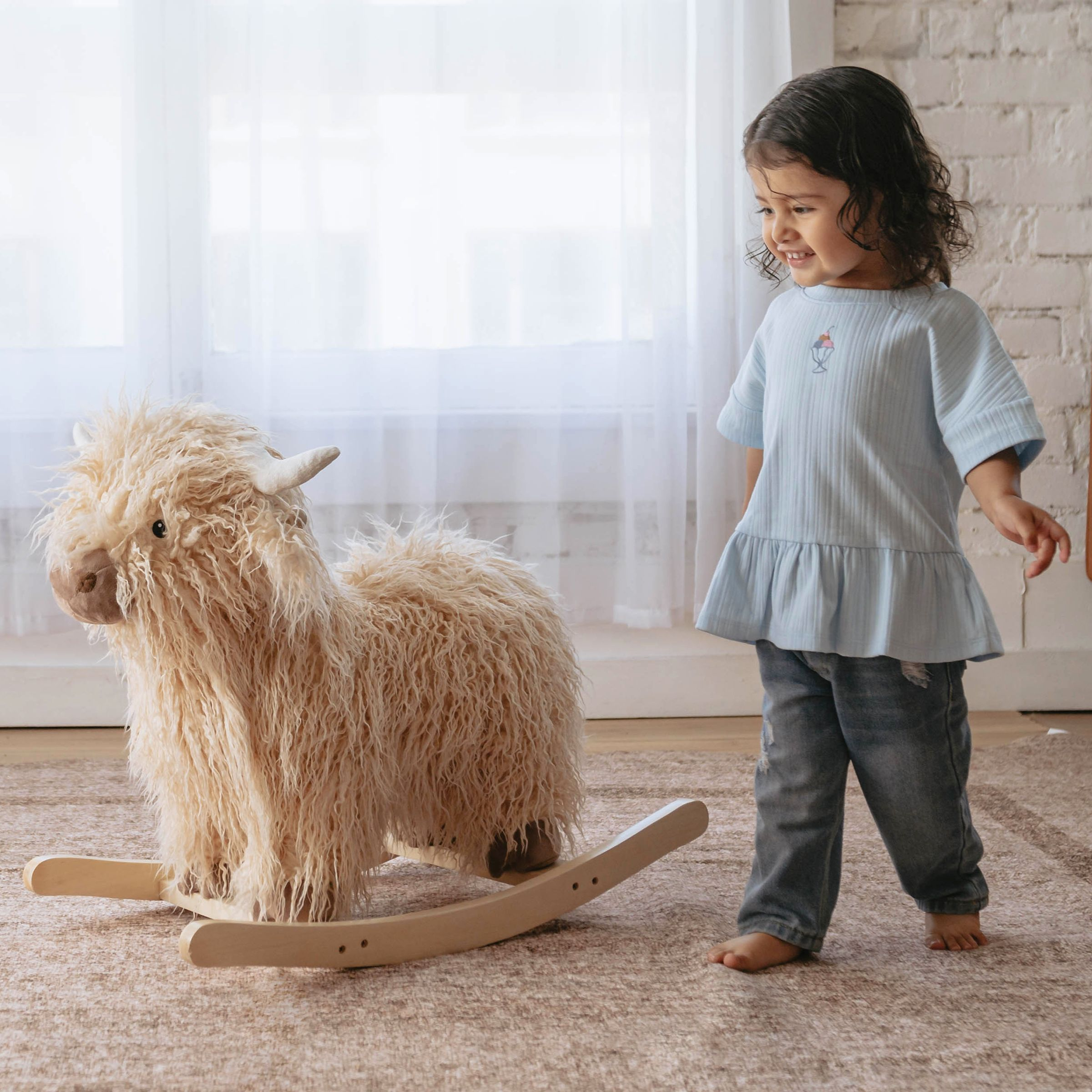 Wonder & Wise Highland Cow Rocker.
