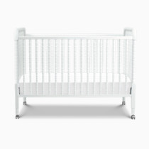 Front view of white Jenny Lind crib with wheels